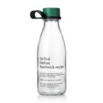 500ml glass water bottle with clear milk bottle shape, green cap, black carry loop and black recipe typography print