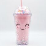 Kawaii tumbler with straw in pink, purple and blue cute face designs with pastel bead filled double wall and rainbow dome lid