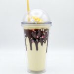 Milkshake style double wall plastic tumbler with straw, 3D chocolate drip, colorful sprinkles and faux whipped cream under a clear dome lid